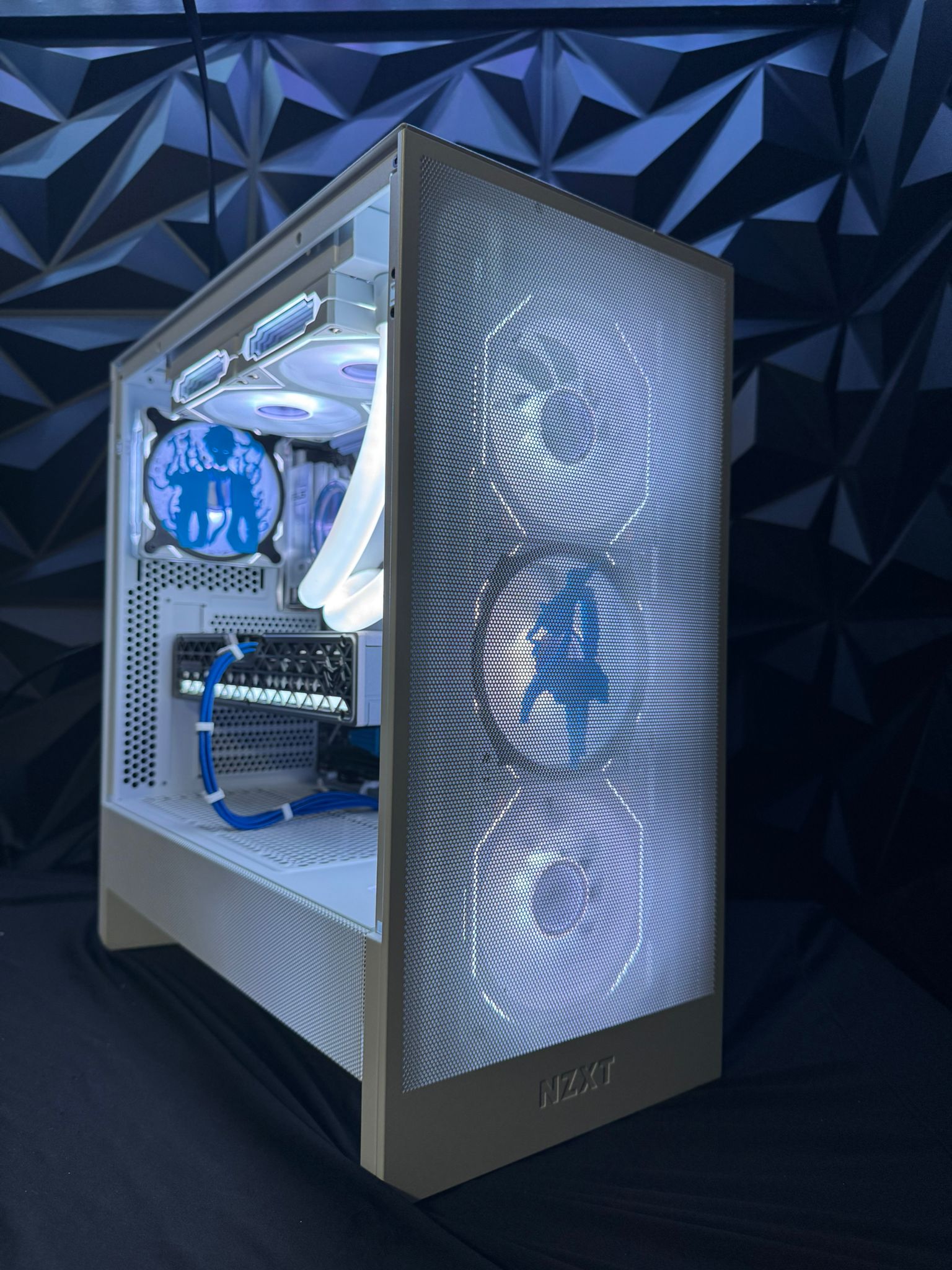 Computer case with blue lighting and geometric background