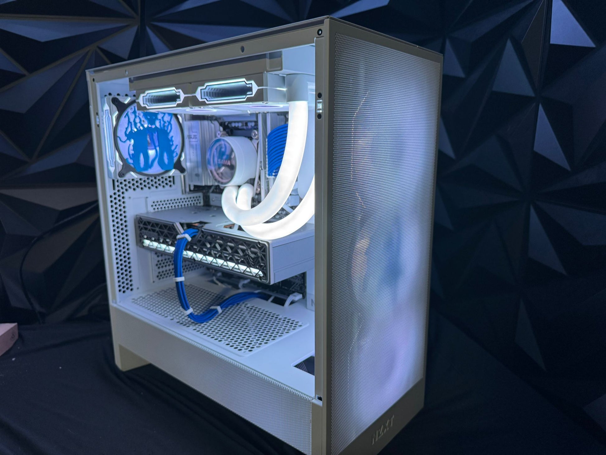 Computer case with visible internal components against a dark geometric patterned background