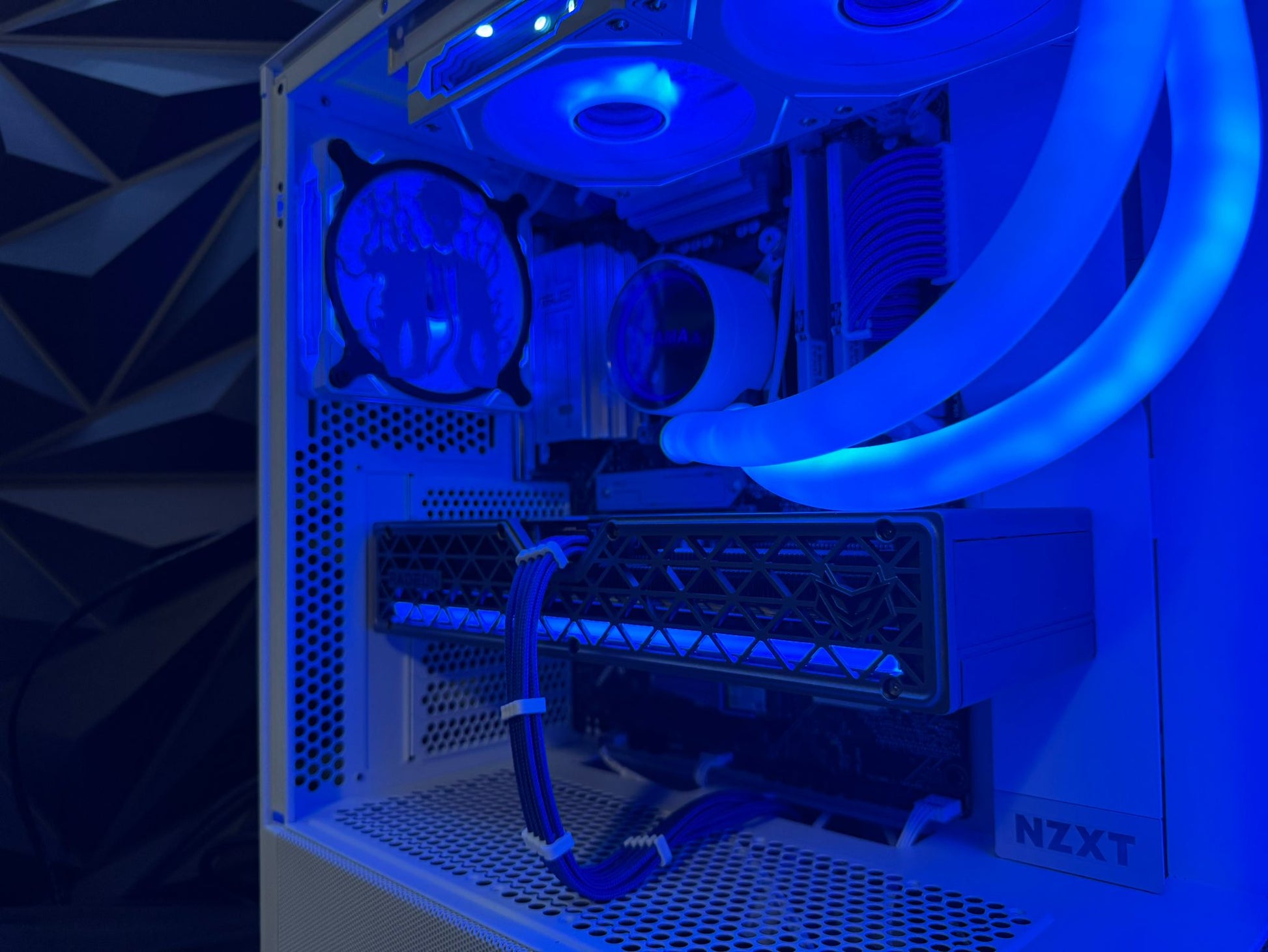 Close-up of a computer case with cooling system and NZXT branding.