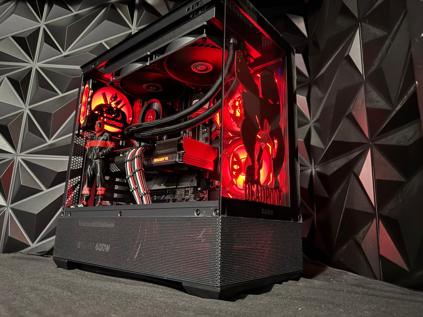 Computer case with red lighting against a geometric patterned wall